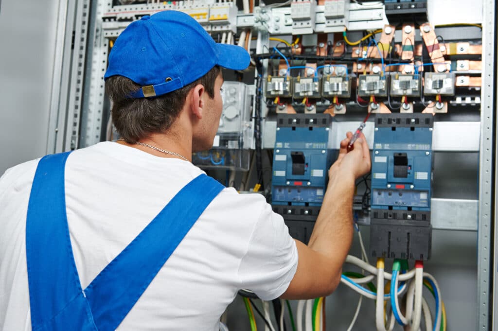 electrician engineer worker checks electrical equipment for repair