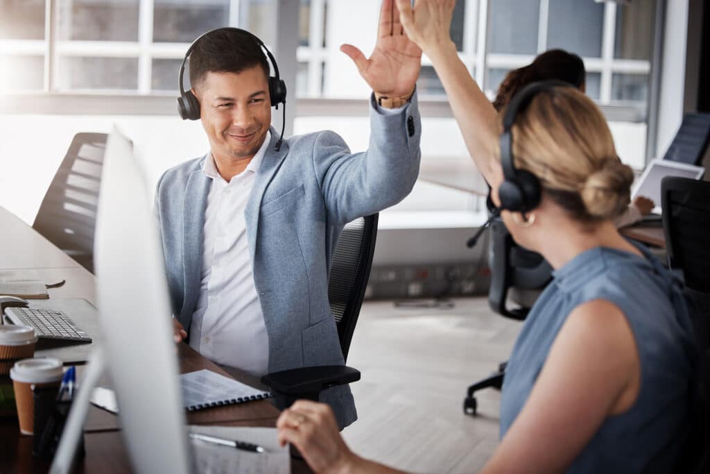 Customer support high five, consulting and happy people celebrate telemarketing on contact us CRM or ERP telecom.