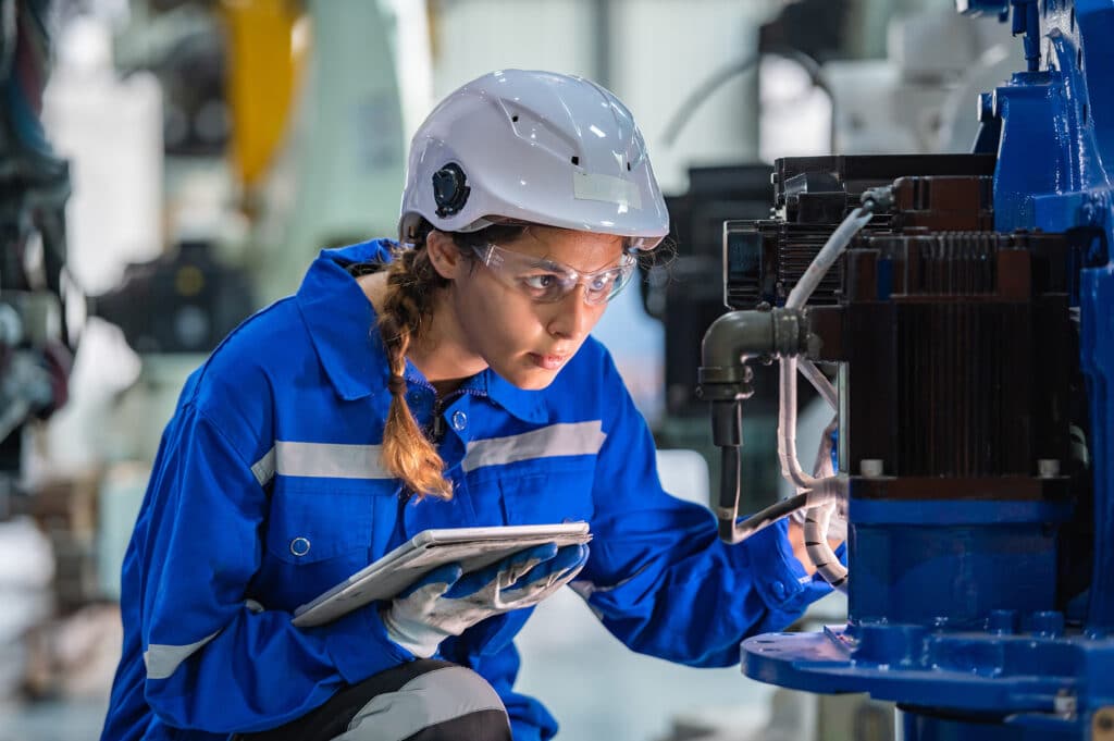 woman engineer in uniform helmet inspection check control heavy machine